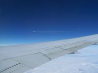 UNKNOWN - Onboard a B767, flying somewhere between Iceland and Canada.  This aircraft was about a mile away and flew right over us about 1000 ft.  It was awsome watching the contrails vaporate as it went by. - by J.B. Barbour