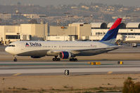 N137DL @ LAX - Delta Airlines N137DL (FLT DAL2089) holding short of RWY 25R after arrival from Hartsfield-Jackson Atlanta Int'l (KATL) - a 4 hour 18 minute flight this day. - by Dean Heald