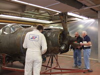 44-2911 @ IAG - Bell technician examines the museum's newest acquisition - by Jim Uber