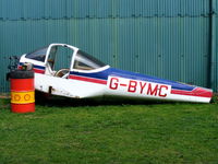 G-BYMC @ EGBO - remains of G-BYMC between the hangars at Halfpenny Green - by Chris Hall
