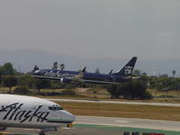 N548AS @ LAX - Landing on 24R while passing Alaska N612AS - by Helicopterfriend