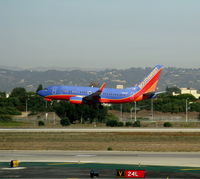 N414WN @ LAX - Southwest 2001 Boeing 737-7H4 in new colors with winglets nears touchdown - by Steve Nation