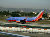 N414WN @ LAX - Southwest 2001 Boeing 737-7H4 in new colors with winglets rolling on runway 24L - by Steve Nation