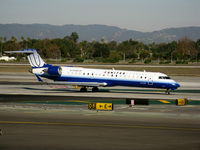 N758SK @ LAX - United Express 2005 Bombardier CL-600-2C10 in latest colors (small Sky West Airlines titles) taxiing to RW 24L - by Steve Nation