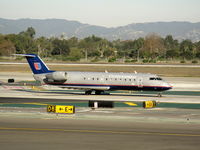 N926SW @ LAX - United Express 2002 Bombardier CL-600-2B19 in earlier colors taxiing to RW 24L - by Steve Nation