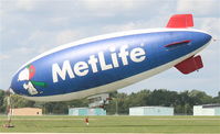 N615LG @ KDPA - MetLife, American Blimp Corp A60R, N615LG- Will someone please help me hold this thing down! - by Mark Kalfas