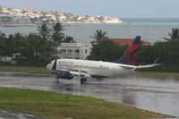 N306DQ @ TNCM - landing on a wet runway 10 - by daniel jef