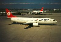 TC-JEZ @ LSGG - Turkish Airlines Boeing 737 named Bergama departing Geneva in March 1994. - by Peter Nicholson