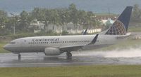 N15712 @ TNCM - Continental airline taking off on a very wet runway. - by Daniel jef