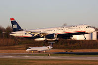 N535UW @ CLT - US Airways N535UW (FLT AWE303) from Denver Int'l (KDEN) landing RWY 18C, with a Continental Express ERJ holding short. - by Dean Heald