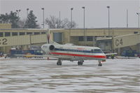 N855AE @ CID - Pulling out of the gate during light snow - by Glenn E. Chatfield