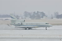 N12U @ CID - Rolling out after landing on Runway 27 during snow shower - by Glenn E. Chatfield