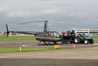 G-MGWI @ EGNM - Robinson R-44 Astro refuelling at Leeds Bradford Airport in 2006 - by Malcolm Clarke