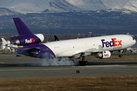 N583FE @ PANC - Smokes the mains on Rwy 14 at Anchorage. - by Michael Carter