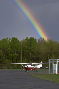 C-GINS @ CYCC - A dark sky and a rainbow serve as a beautiful backdrop for C-GINS as it readies to depart into clear skies to the west. - by Skylane77