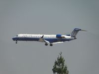 N766SK @ ONT - United Express operated by Sky West coming out of the haze on final to Ontario - by Helicopterfriend