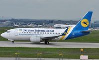 UR-GAT @ EDDF - Ukraine taxiing for take-off with a long-haul rolling in the distance - by Robert Kearney