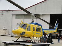N205BH @ CMA - Tail boom being held up by forklift while mechanics work on it - by Helicopterfriend