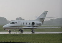 N220KS @ KDPA - T M D F LLC Dassault-breguet FALCON 10, on taxiway R6 KDPA after arriving in heavy showers. - by Mark Kalfas