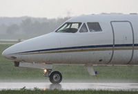 N220KS @ KDPA - T M D F LLC Dassault-breguet FALCON 10, on taxiway W6 KDPA after arriving in heavy showers. - by Mark Kalfas