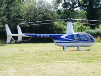 G-BYKK @ X2FF - Robinson R44 being used for ferrying race fans to Silverstone for the British Grand Prix from this temporary heliport a few miles east of Bicester - by Chris Hall
