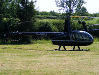 G-OHLI @ X2FF - Robinson R44 being used for ferrying race fans to Silverstone for the British Grand Prix from this temporary heliport a few miles east of Bicester - by Chris Hall