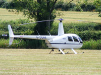 G-CGNE @ X2FF - Robinson R44 being used for ferrying race fans to Silverstone for the British Grand Prix from this temporary heliport a few miles east of Bicester - by Chris Hall