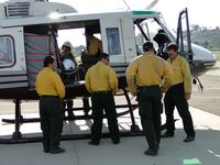 N510WW @ POC - Fire fighting crew putting on jackets and getting ready to board for flight to Ramona, Ca - by Helicopterfriend