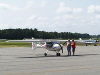 N30748 @ GWW - Pilot discusses aircraft with Goldsboro-Wayne employee - by George Zimmerman