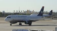 N669AW @ KPHX - Taxiing to Gate at PHX - by Todd Royer