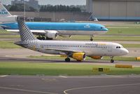 EC-HQI @ EHAM - Vueling taxiing in after arrival while a heavy KLM departs - by Robert Kearney