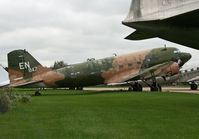 N88874 @ KOSH - A Convairliner's tail frames a fine DC-3 at Basler Turbo Conversions, Oshkosh, WI. - by Daniel L. Berek