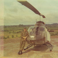 68-16864 - Sgt. West and 864 setting outside an engineering compound in Viet Nam. The copilot's armor plate has been left hanging open.  Oh, she looks so new! - by Bookie