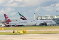 G-VROY @ EGCC - Virgin Atlantic B747 taxing past the Emirates A380 - by Chris Hall