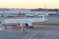 A6-ETC @ EGCC - Etihad Airways B777 pulling onto its gate - by Chris Hall
