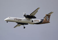 N400QX @ KSEA - Seen on approach to KSEA is the first Horizon Air Q400. Aircraft is now one of the latest college logo props as it has been adorned in the colors of the University of Idaho Vandals. - by Joe G. Walker