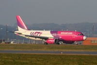 HA-LWB @ EGGW - Wizzair A320 taxying to the apron after landing on RW26 - by Chris Hall