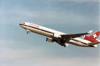 HB-IWA @ GVA - MD-11 of Swissair climbing out of Geneva in March 1993. - by Peter Nicholson