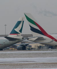 B-HUH @ EGCC - Cathay Pacific B747 taxying past Emirates A380 - by Chris Hall