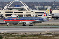 N320AA @ LAX - American Airlines Flagship Independence N320AA (FLT AAL3) holding short of RWY 25R on Taxiway Papa after arrival on RWY 25L from John F Kennedy Int'l (KJFK). The logo says In support of all who serve and the aircraft has a yellow ribbon on the tail. - by Dean Heald