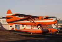 N644JJ @ CYVR - An orange Turbo Otter in the orange light of dawn new year's day 2011 - by Duncan Kirk