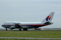 9M-MPG @ EHAM - Malaysia Airlines 747-400 rolling out at Schiphol airport. - by Henk van Capelle