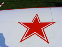 G-BWSV @ EGTR - Russian star on the wing of Yak-52 G-BWSV - by Chris Hall