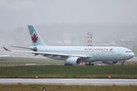 C-GHKW @ LSZH - On the way to rwy 18 during heavy rainshowers - by Raybin