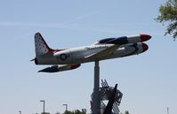 57-0598 @ LAL - T-33 on a pole in Thunderbirds colors at a School next to Florida Aviation museum - by Florida Metal
