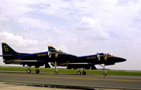 155056 @ HRL - A-4F Skyhawk Blue Angels number 6 with Blue Angel number 5 154983 taxying to the active runway at rthe 1978 Confederate Air Force's Harlingen Airshow. - by Peter Nicholson
