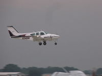 N34BW @ KOSH - landing during the rain EAA2011 - by steveowen
