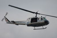 N416NA - NASA UH-1B flying over Indian River at Titusville - by Florida Metal