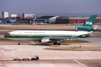 AP-AXD @ EGLL - taxiing past the Queen's Building - by John Meneely