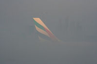 A6-EKT @ EGCC - Emirates A330 taxiing through the early morning fog - by Chris Hall